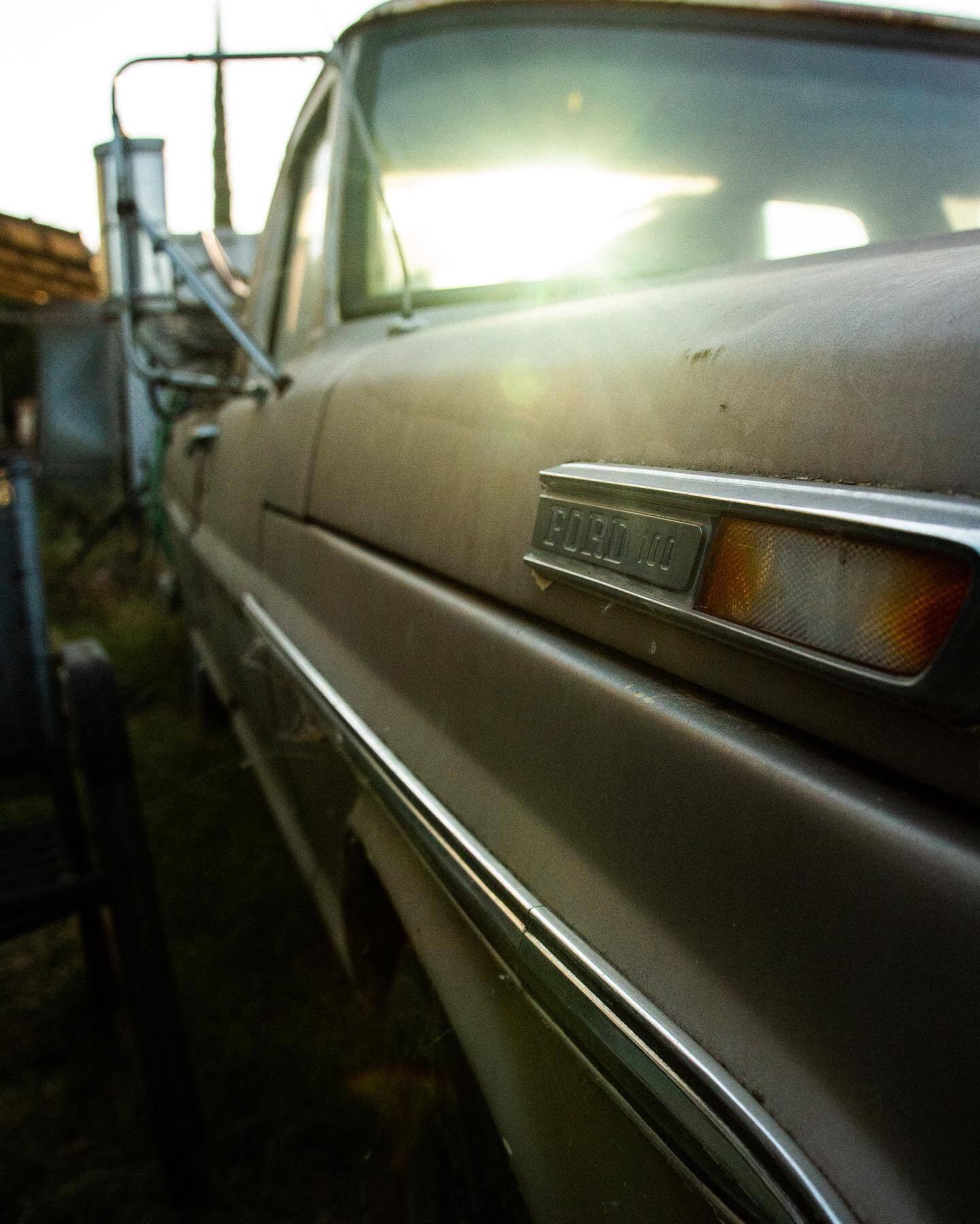 The chrome flank of an old car catching low sun